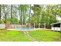 Expansive backyard with pool, pergola, and mature trees perfect for entertaining and outdoor living at 307 Fairington Dr, Summerville, SC 29485