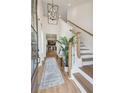 Inviting entryway featuring a staircase, light hardwood floors, and a stylish chandelier at 316 Abercom Place Dr, Moncks Corner, SC 29461