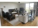 Spacious living room with hardwood floors, comfortable seating, elegant decor, and large windows for natural light, perfect for relaxation and entertainment at 330 Concord St # 4B, Charleston, SC 29401