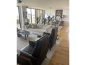 Bright living room features hardwood floors, a plush white sofa, stylish decor, and balcony access, creating a modern and inviting space at 330 Concord St # 4B, Charleston, SC 29401