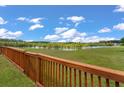 Scenic backyard view of a peaceful pond from the wooden fence at 364 Deep River Rd, Summerville, SC 29486