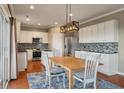 Bright kitchen with white cabinets, stainless steel appliances, and a stylish backsplash at 364 Deep River Rd, Summerville, SC 29486