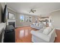 Spacious living room with hardwood floors, a fireplace, and large windows at 364 Deep River Rd, Summerville, SC 29486
