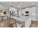 Bright white kitchen boasts a large island with seating and stainless steel appliances at 3968 Hanoverian Dr, Mount Pleasant, SC 29429