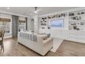 Cozy living room showcases a built-in bookshelf, a ceiling fan, and a comfortable sofa at 3968 Hanoverian Dr, Mount Pleasant, SC 29429