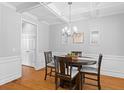 Elegant dining room featuring a modern chandelier, wainscoting, and access to other rooms at 408 Branch Creek Trl, Summerville, SC 29483