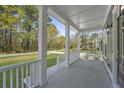 Inviting front porch showcasing classic white columns and scenic neighborhood view at 4209 Royal Harbor Rd, Hollywood, SC 29449
