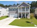 Beautiful two-story home with a welcoming porch and well-kept landscaping at 4310 Cotton Flat Rd, Summerville, SC 29485