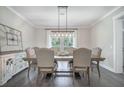 Bright dining room features a wooden table with seating for six and a stylish chandelier at 4332 John Hatch Dr, Johns Island, SC 29455