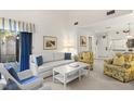 Cozy living room with a white sofa, floral armchairs, and access to an outdoor patio with seating at 4338 Sea Forest Dr, Kiawah Island, SC 29455