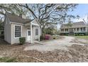 Exterior view of home with a separate guest house, lush landscaping, and circular driveway at 4584 Olde Smoak House Rd, Meggett, SC 29449