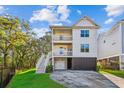 Charming three-story home with double balconies and staircase leading to a garage at 5035 Gum Tree Ln, Johns Island, SC 29455