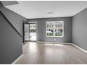 Bright living room with new laminate flooring, grey walls, and lots of natural light at 507 Stinson Dr # 7F, Charleston, SC 29407