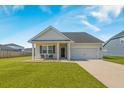 Inviting home featuring a two-car garage and covered front porch, offering comfortable curb appeal at 706 Squire Pope Rd, Summerville, SC 29486