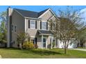 Charming two-story home featuring a well-manicured lawn, attached garage, and classic black shutters at 712 Bent Hickory Rd, Charleston, SC 29414