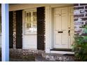 Charming front door of the home with brick exterior and shuttered windows at 731 Pitt St, Mount Pleasant, SC 29464