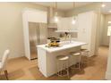 Modern kitchen with stainless steel appliances, subway tile backsplash, island with seating, and abundant counter space at 7424 Indigo Palms Way, Johns Island, SC 29455