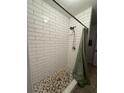 Updated shower with subway tile and decorative pebble floor at 7724 Linsley Dr, North Charleston, SC 29418