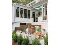 Outdoor living area features a built-in grill, and comfortable striped seating perfect for entertaining guests at 791 Hughes Rd, Johns Island, SC 29455