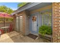 Cozy front patio with a brick floor, outdoor seating, and decorative plants near the entry at 8 Duffers Ct. # A, Charleston, SC 29414