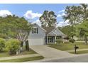 Charming single-Gathering home with an attached garage, established trees, and a well-maintained lawn at 8001 Hydrangea Ln, Hanahan, SC 29410