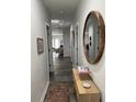 Bright hallway featuring wood floors, a decorative mirror, and stylish console table at 928 Sycamore Ave, Charleston, SC 29407