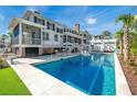 Backyard oasis with a sparkling pool, sun loungers, outdoor seating, and covered patio for ultimate relaxation at 1075 Avenue Of Oaks, Charleston, SC 29407