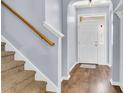 Bright entryway featuring hardwood floors, a staircase, and a view of the front door at 117 Back Tee Cir, Summerville, SC 29485