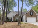 Beautiful home featuring a mix of brick and white siding, complemented by a two-car garage and mature trees at 1177 Old Ivy Way, Mount Pleasant, SC 29466