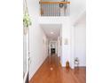Inviting entryway with gleaming hardwood floors and an open staircase to the second level at 120 Fresh Meadow Ln, Mount Pleasant, SC 29466