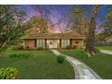 Charming single story home at dusk with manicured lawn, brick facade, and stone walkway at 123 Tiffany Ln, Summerville, SC 29485