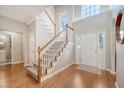 Grand foyer featuring hardwood floors, staircase with wood railings, and plenty of natural light from the arched window at 1310 Belhaven Dr, Mount Pleasant, SC 29466