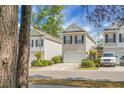 Charming townhouse with neutral siding, black shutters, a one car garage and well-maintained landscaping at 1314 Garland St, North Charleston, SC 29420