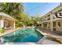Backyard showcasing a spacious pool, cabana, and lounge area, perfect for outdoor entertaining at 1316 Thompson, Sullivans Island, SC 29482