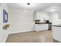 Eat-in kitchen area featuring modern white cabinets, sleek countertops, and stainless steel appliances, adjacent to dining area at 1402 Camp Rd # 10C, Charleston, SC 29412