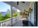 Relaxing porch with white railings, ceiling fans, comfortable seating and neighborhood views at 147 Musket Loop, Summerville, SC 29483