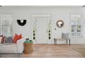 Bright living room with wood floors, large windows, and modern décor, creating a welcoming atmosphere at 1504 Galloway Ln, Charleston, SC 29412