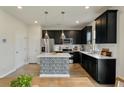 Modern kitchen features dark cabinetry, stainless steel appliances, and stylish central island at 163 Cypress Plantation Rd, Moncks Corner, SC 29461