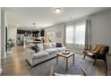 Bright and airy living room with hardwood floors that flows into a modern kitchen at 163 Cypress Plantation Rd, Moncks Corner, SC 29461