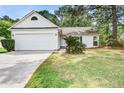 Bright, one story home featuring an attached garage, a green lawn, and a quaint front garden at 1708 Eallystockert Rd, Charleston, SC 29414