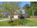 Charming two-story home with stone accents, attached two car garage, surrounded by mature trees at 1723 Indaba Way, Charleston, SC 29414