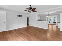 Open concept living room with hardwood floors, stylish ceiling fan, and access to the patio at 1785 N Mayflower Dr, Charleston, SC 29412