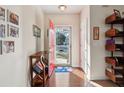 Inviting entryway featuring hardwood floors, a red front door, and stylish shelving for storage and decor at 1906 Cedar Petal Ln, Charleston, SC 29414