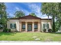 Stately home featuring a columned portico entrance, shutters, and lush lawn at 2 Leone Ln, Hanahan, SC 29410