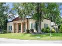 Traditional home featuring a columned portico entrance, shutters, and mature landscaping at 2 Leone Ln, Hanahan, SC 29410