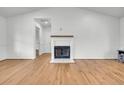 Bright, open living room with shiplap wall, fireplace, and hardwood flooring at 217 Mini Farm Rd, Bonneau, SC 29431