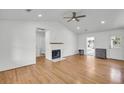 Bright living room with hardwood floors, shiplap walls, and a modern fireplace at 217 Mini Farm Rd, Bonneau, SC 29431