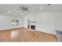 Living room offers hardwood floors, shiplap accent wall and fireplace at 217 Mini Farm Rd, Bonneau, SC 29431