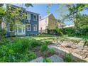 Serene backyard boasts lush greenery, a charming patio set, and plenty of space for relaxation at 22 Ashton St, Charleston, SC 29403