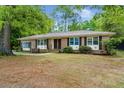 Charming brick home featuring a double-door entry and a covered front porch swing at 223 Dandridge Rd, Walterboro, SC 29488